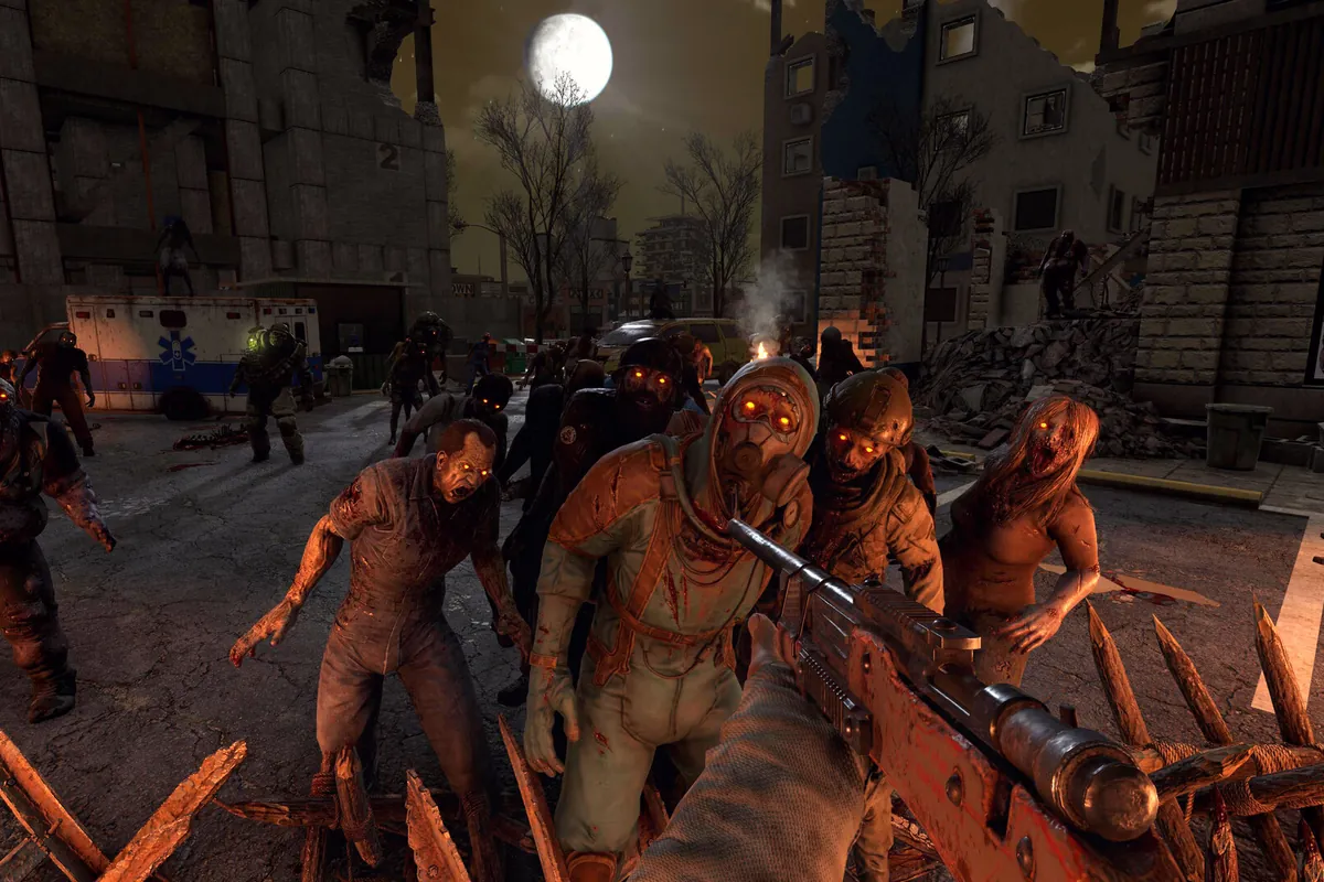 A horde of zombies attacking a spiked base wall at night in 7 Days to Die