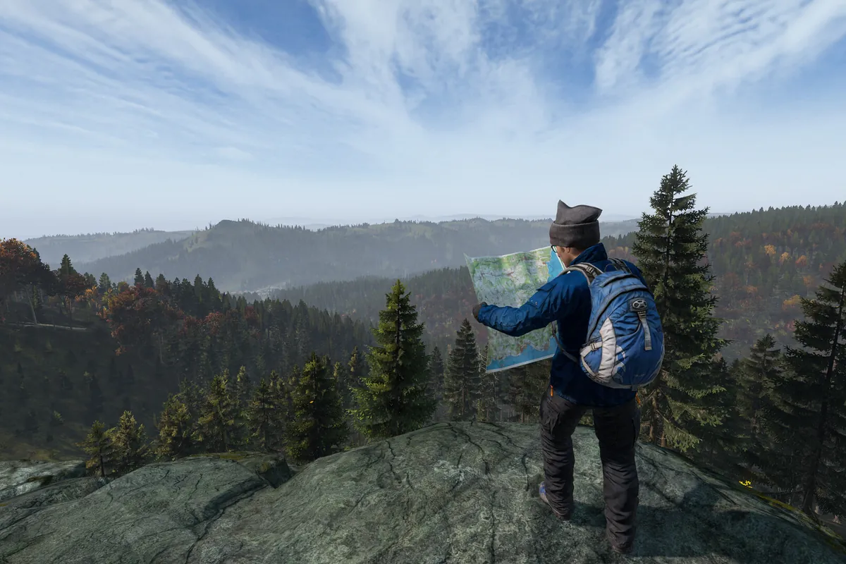 A survivor reading a map on a hilltop overlooking the forest in DayZ