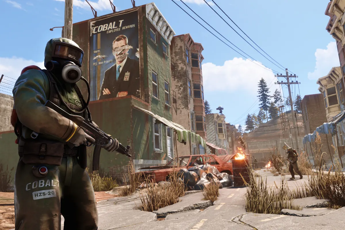 An armed player moving through a ruined town in Rust